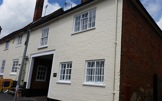 Exterior walls and refurbished windows and painted walls in exterior masonry paint finish. 