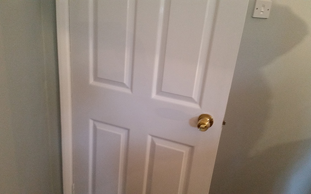 Room with six panel door with gloss finish