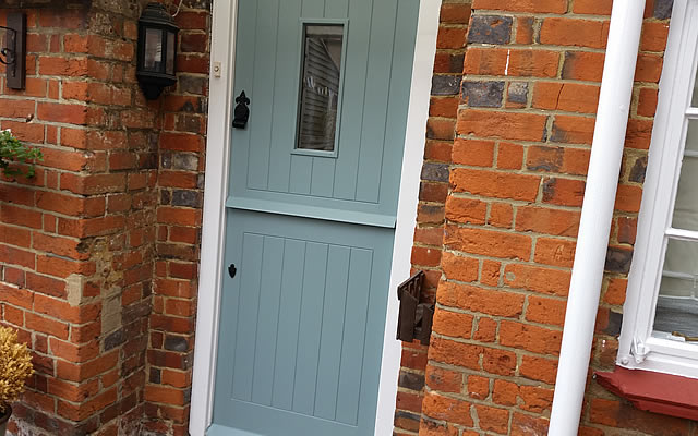 Finished stable door painted in designer paint on listed building