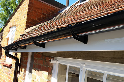 Guttering repairs and replacement of fascia board on listed building