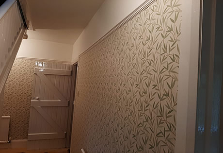 Designer wallpaper and paint in Hallway..